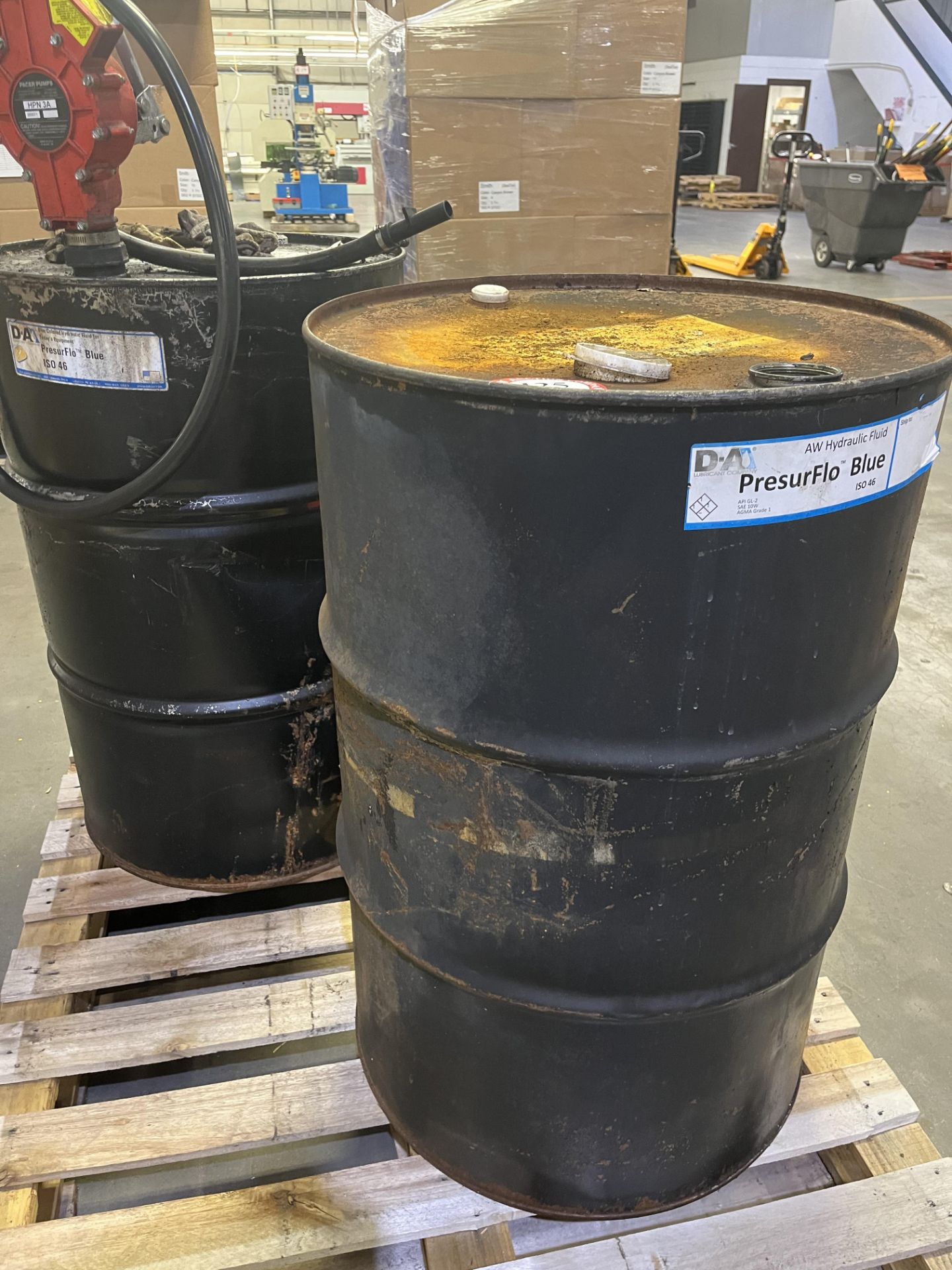 (2) Partial 50-gallon drums of hydraulic fluid , with pump