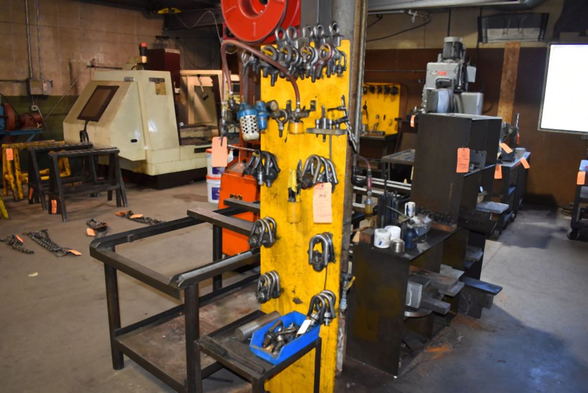 WALL OF MOSTLY EYE BOLTS, CLAMPING, REGULAR, SWIVEL, TIN SNIPS AND SMALL METAL TABLE