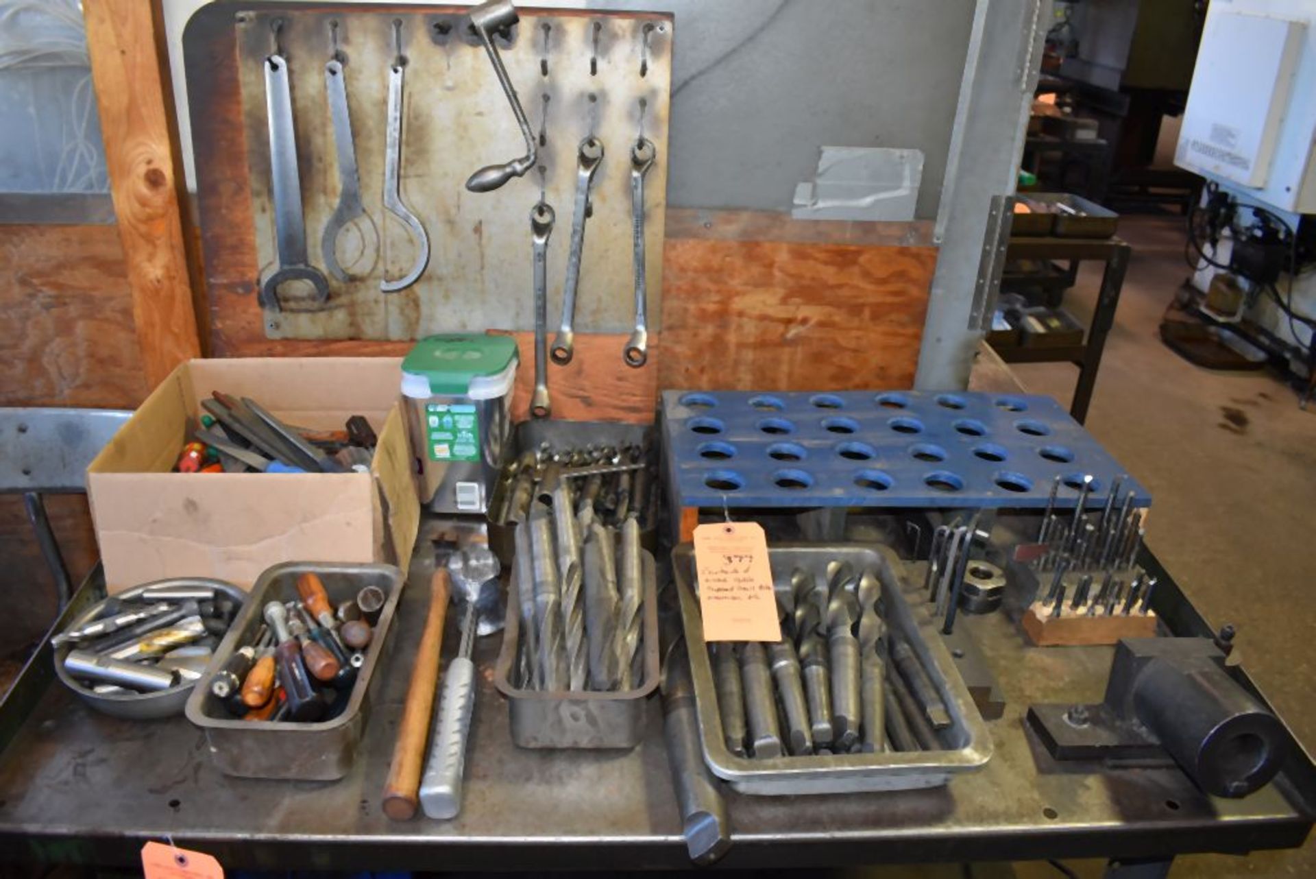 CONTENTS OF WORK TABLE, TAPERED DRILL BITS, WRENCHES, ETC.