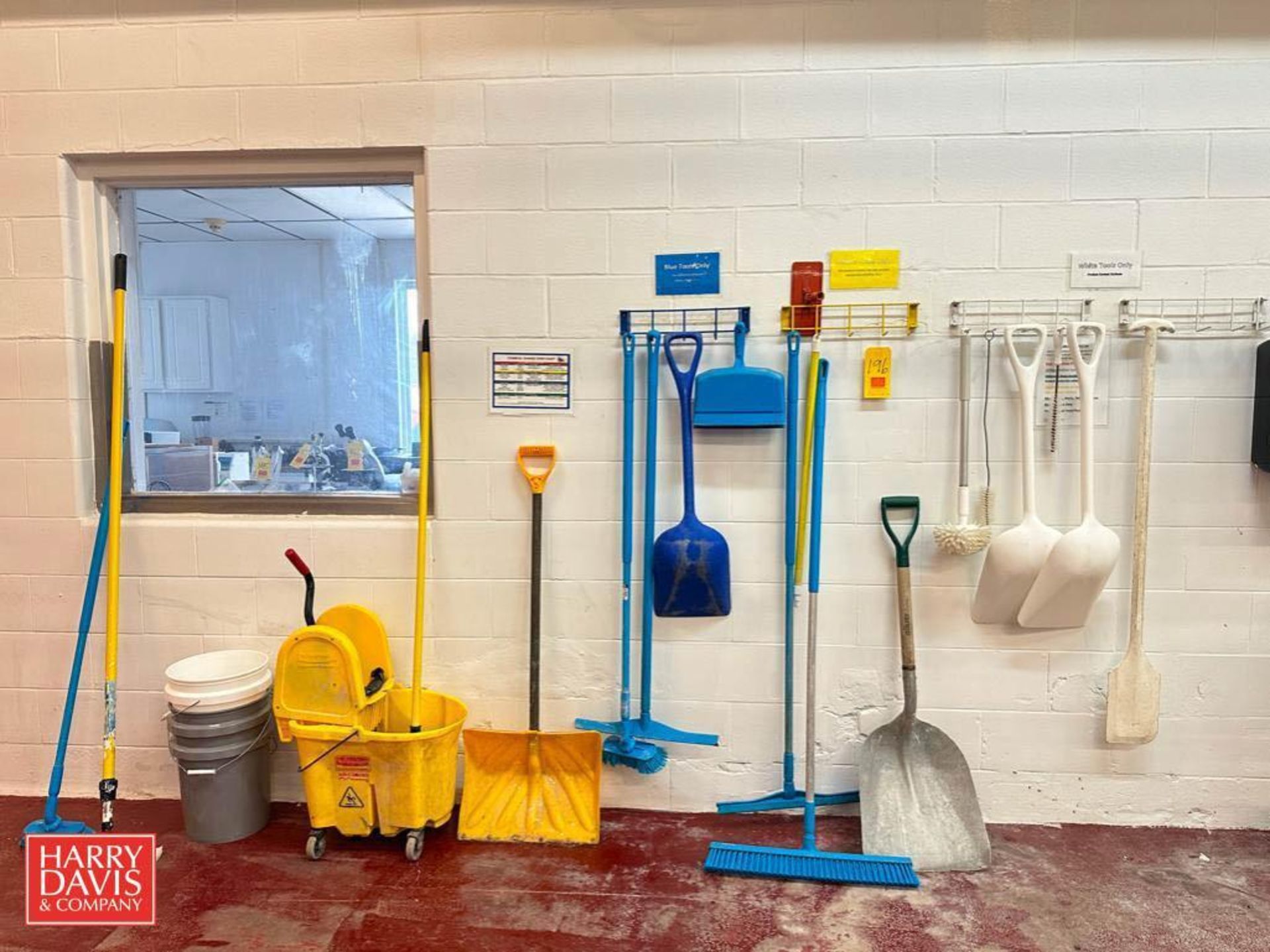 Wall-Mounted Utility Racks with Assorted Shovels, Brooms and Dust Pans
