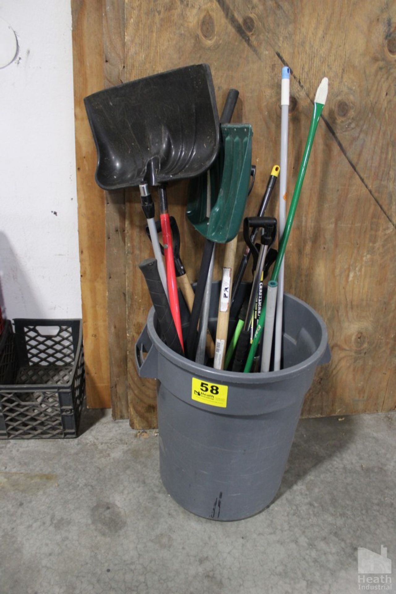 ASSORTED SHOVELS AND BROOMS IN GARBAGE CAN