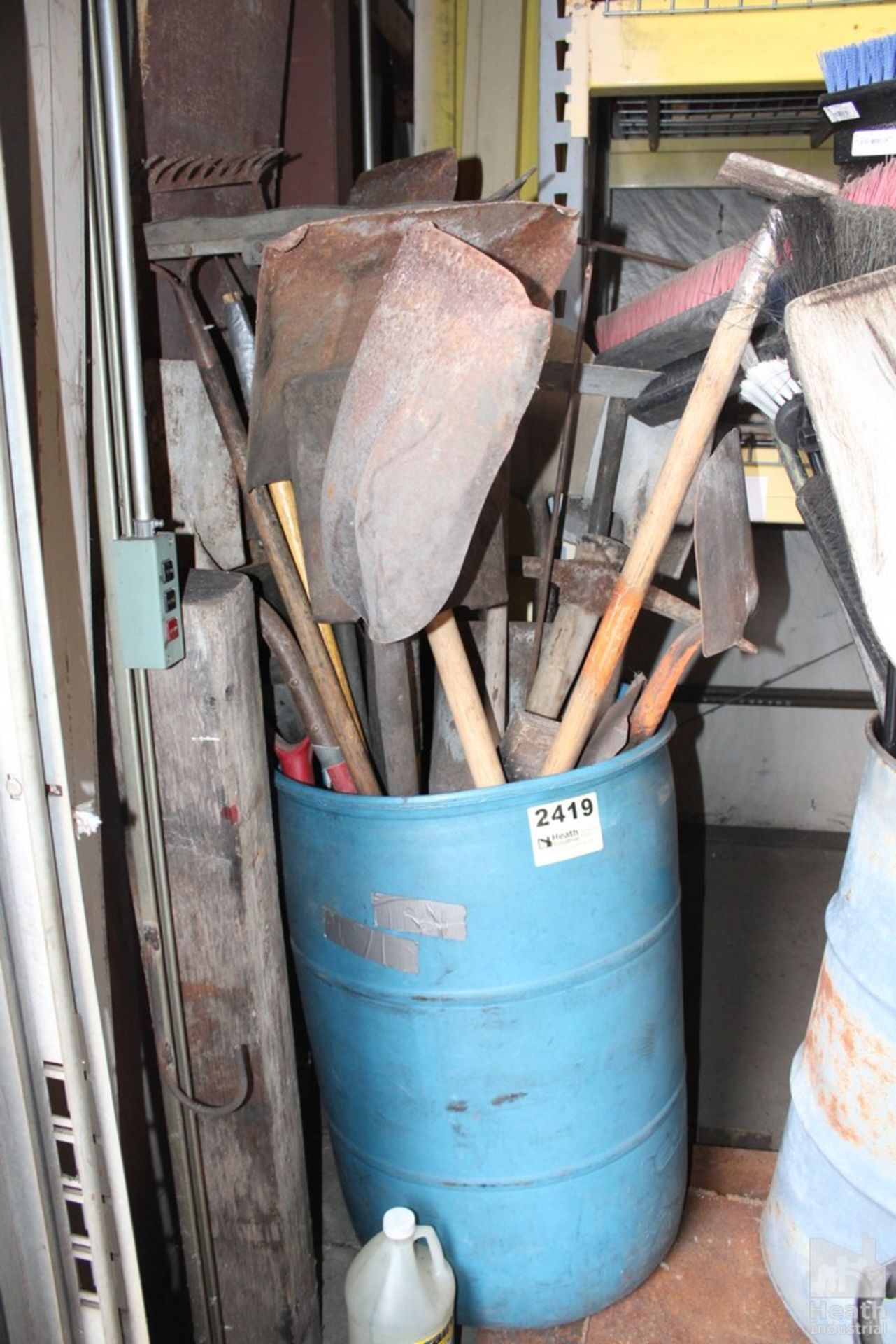 BARREL OF SHOVELS, RAKES AND BROOMS