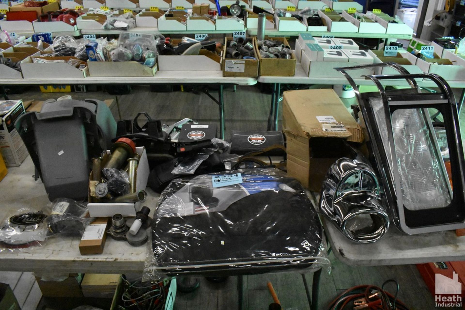 ASSORTED CAR PARTS ON TABLE