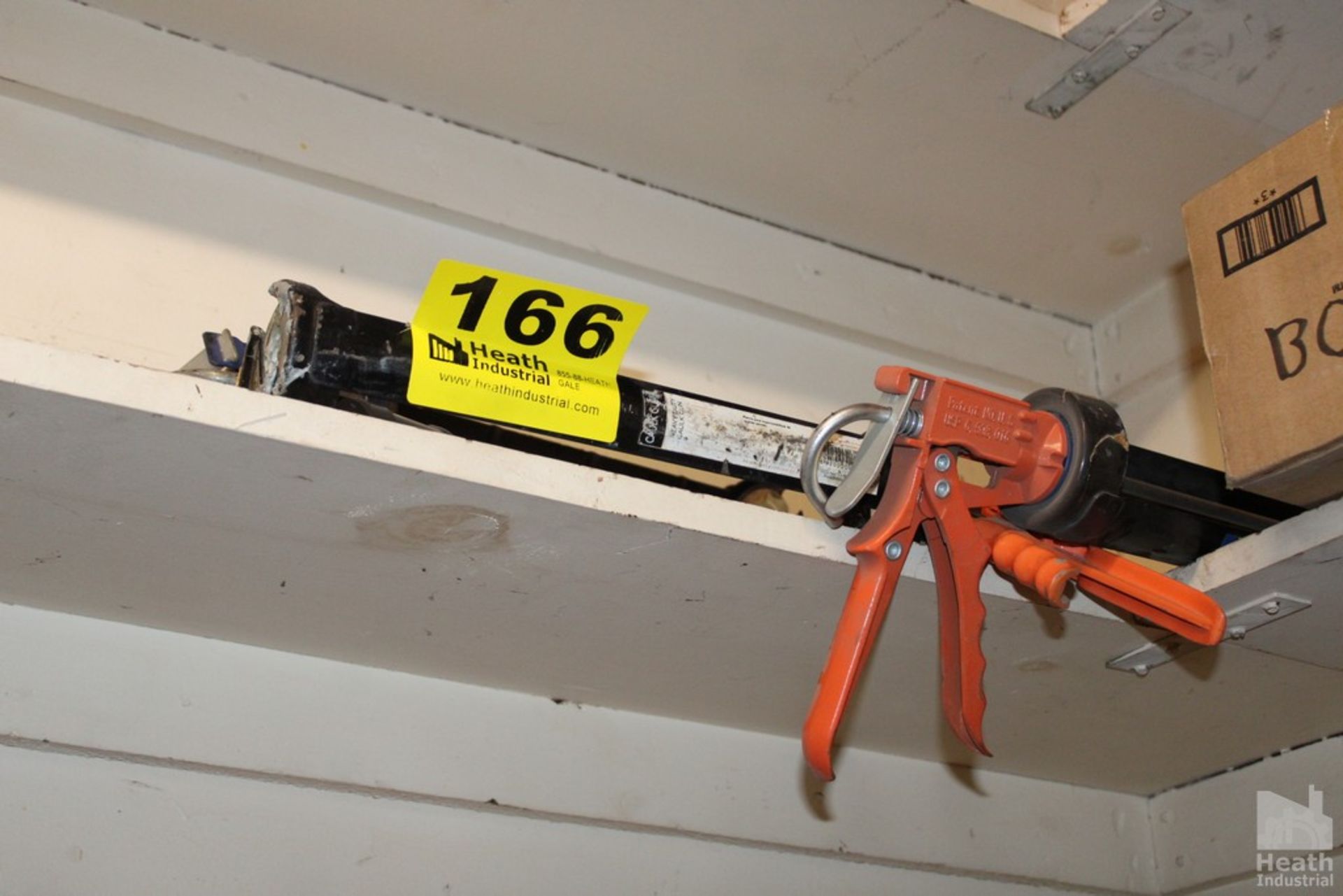 LARGE CAULK GUNS ON SHELF