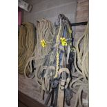 LARGE QUANTITY OF SAFETY HARNESSES ON WALL