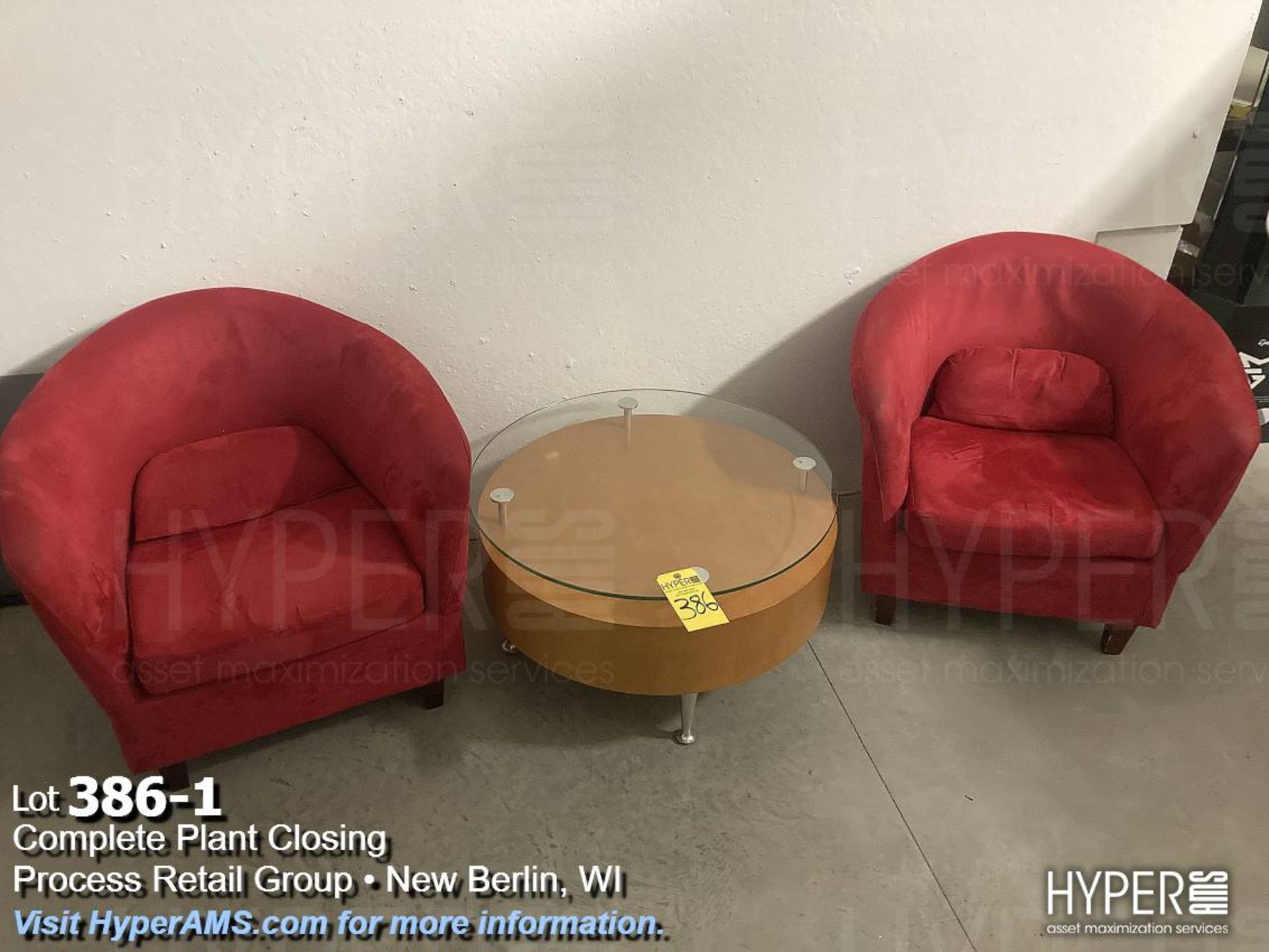 Red sofa chairs, and round glass top table