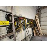 LOT OF HANGING EXTENSION CORDS AND RACK