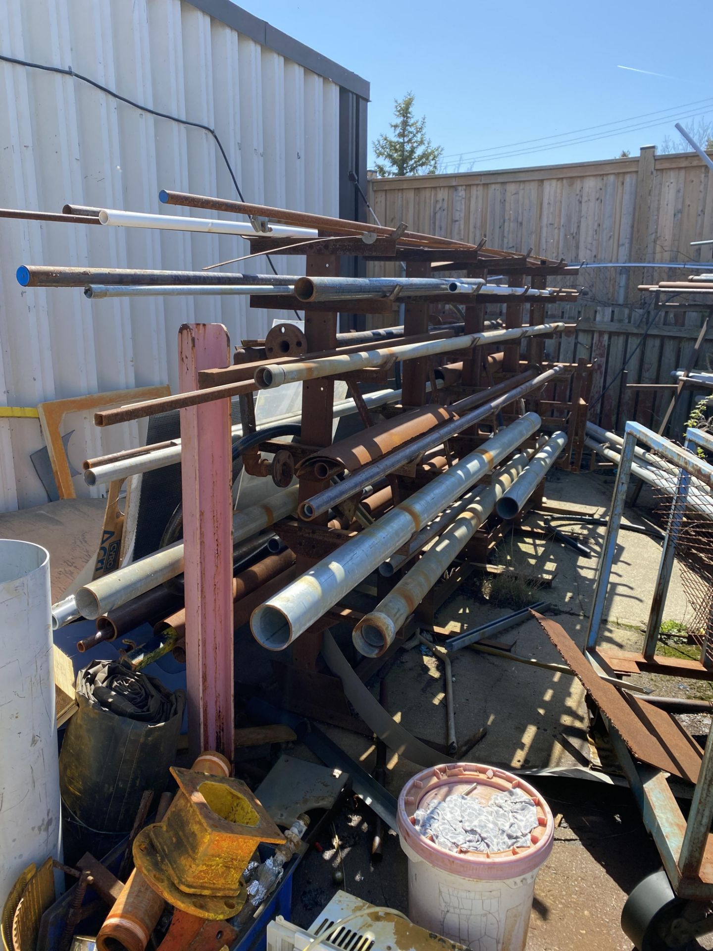 LOT OF (4) METAL STORAGE RACKS W/ PIPE AND CONTENTS (METAL AND PLASTIC), BATTERY ROLLER TRAY, ETC. - Image 2 of 7