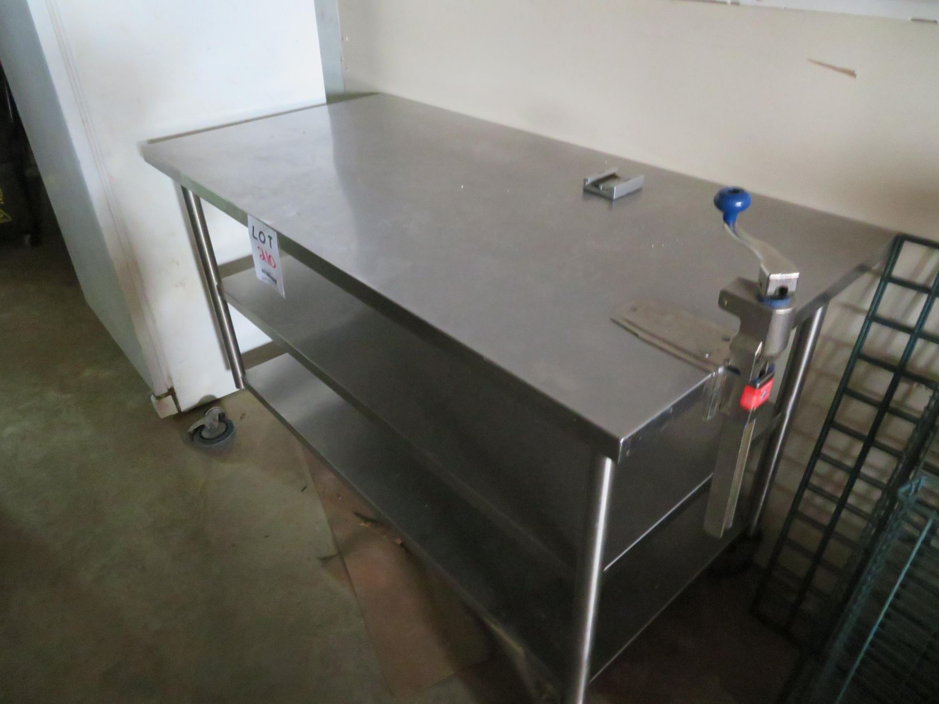 Stainless steel table with can opener approx. 60"w x 30"d x 34"h (AS IS)