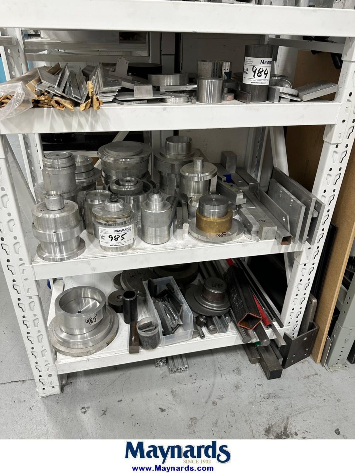 aluminum machine parts on 2 shelves
