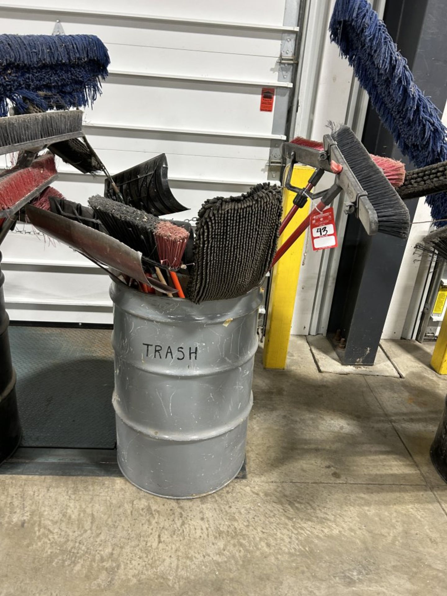 BARREL OF ASSORTED BROOMS, SQUEEGEES, SHOVELS, DUST MOPS, ETC.