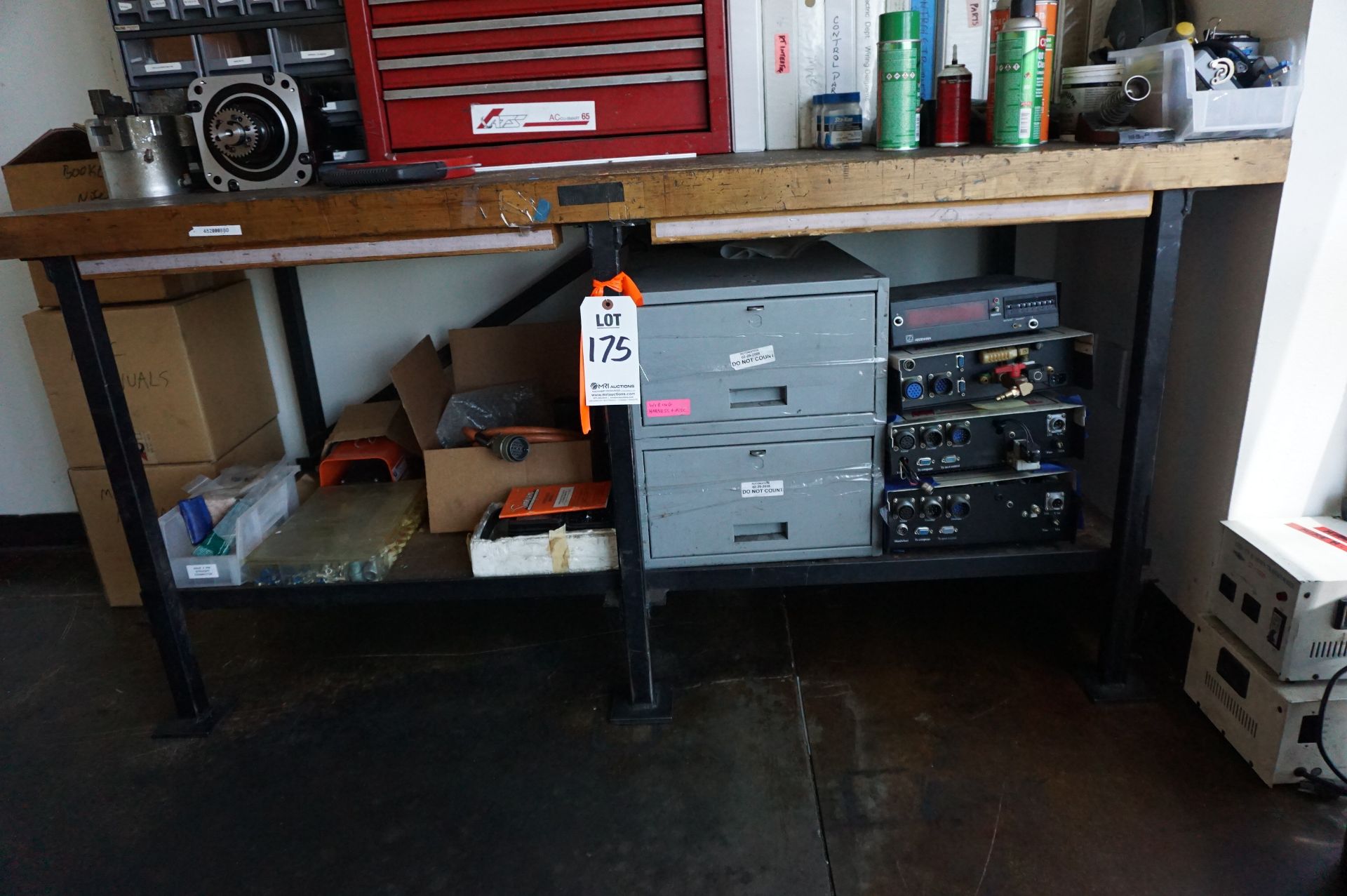 TABLE AND CARTS IN MAINTENANCE ROOM TO INCLUDE: (1) HEAVY DUTY WORK BENCH WOOD TOP STEEL LEGS, 72" X