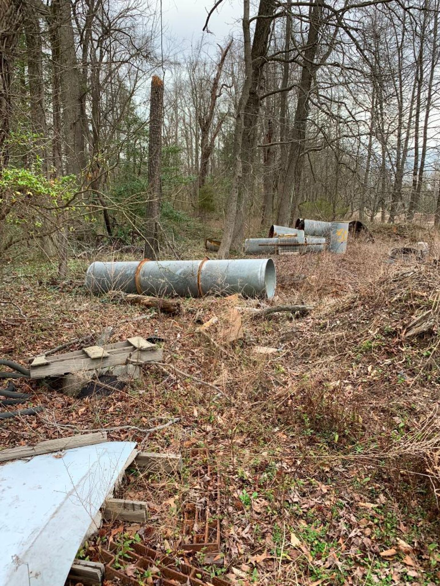 Scrap Content Along Woodline: (3) Sheds, Ducting, Terex Machine Part, Drag Line Bucket, Siding, Rota