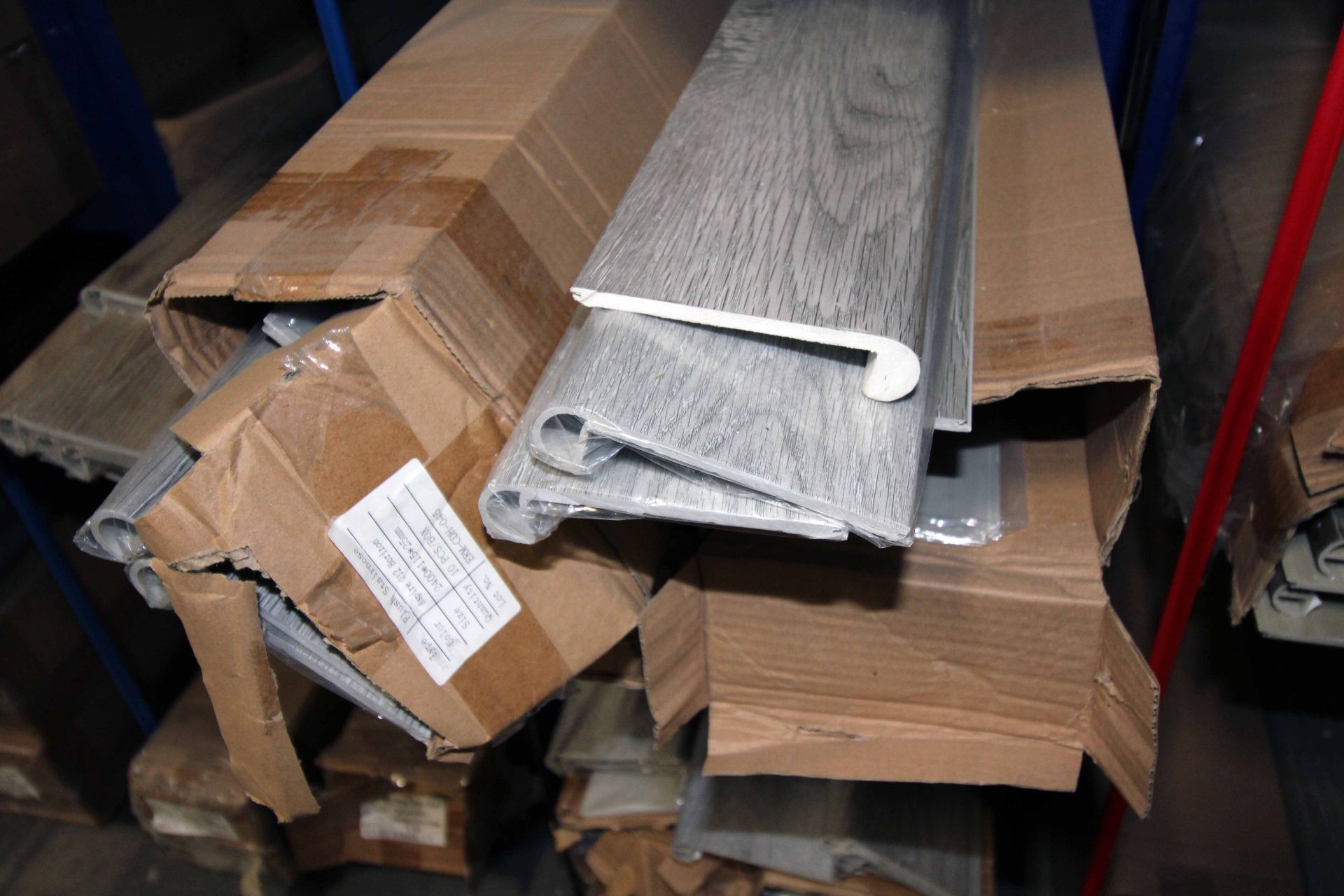 LOT CONSISTING OF: flush stair nose, end cap, T-mold, trim, Horizon, multiple boxes (on one rack) ( - Image 3 of 4