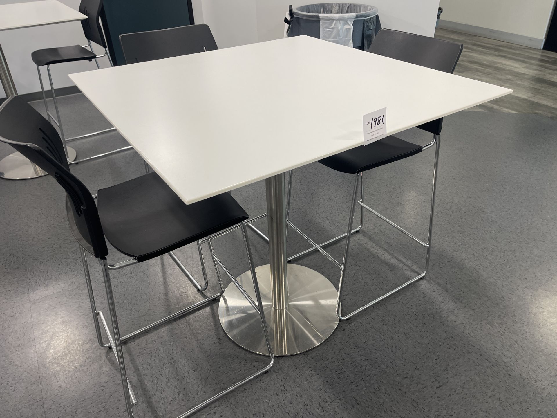 White Square Table with metal base 42" wide x 42" deep x 42" high and three black chairs