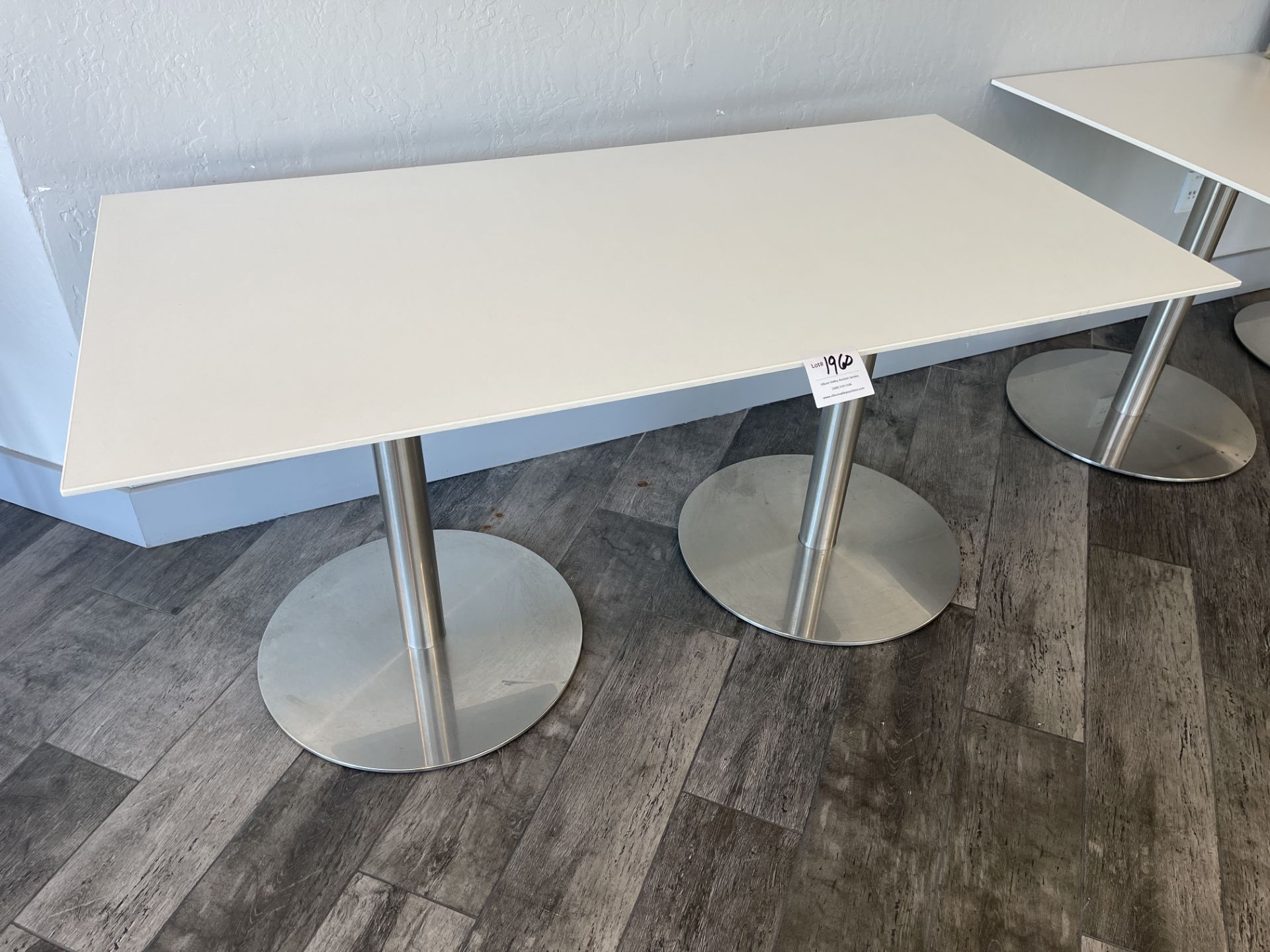 White Table with metal base 60" wide x 30" deep x 29" high and two black chairs