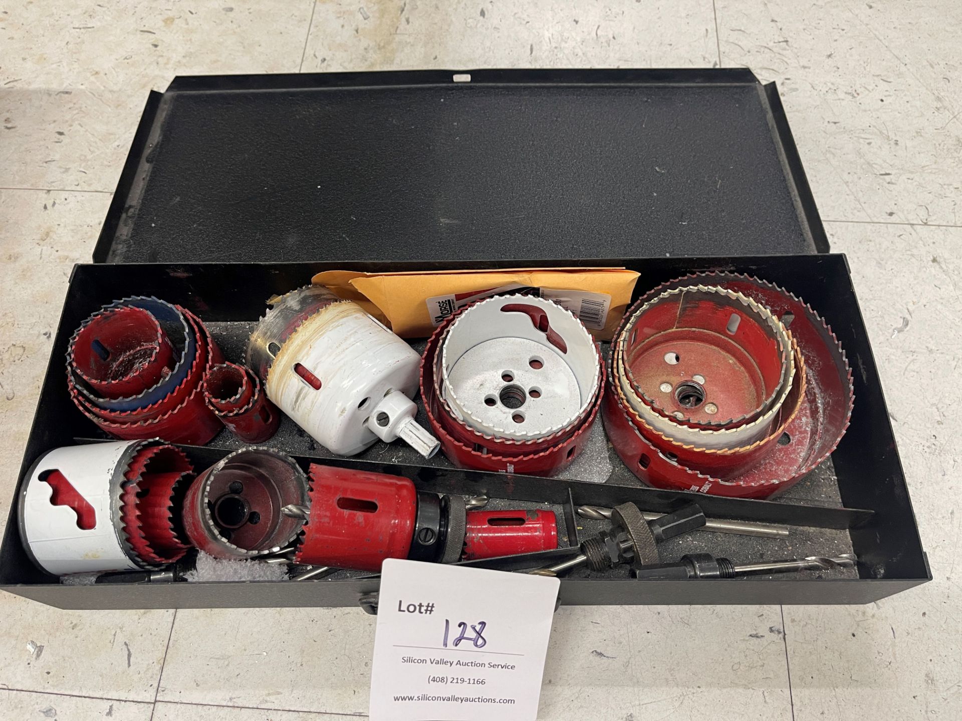 Various hole saws in metal box