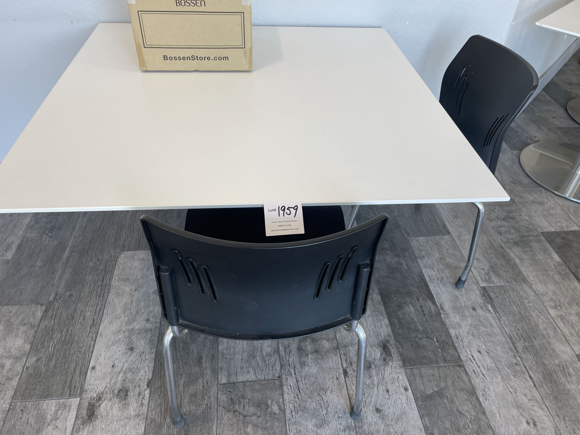 White Square Table with metal base 42" wide x 42" deep x 30" high and one black chair (box on