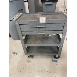 Metal cart with two shelves and three drawers on wheels