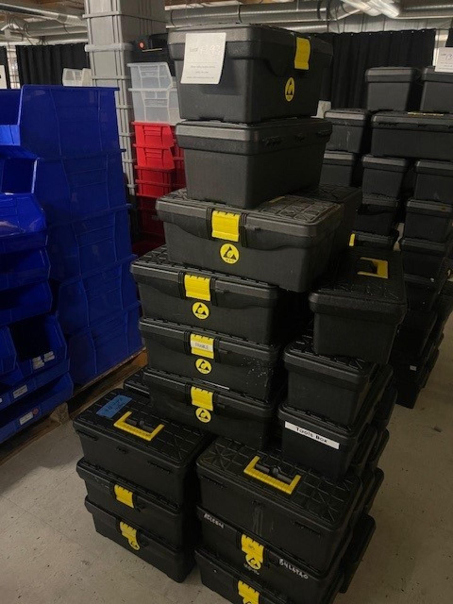 Large lot of black plastic toolboxes