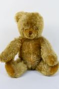 Steiff - an early 20th century Teddy Bear, mohair fur, straw filled, stitched snout and mouth,