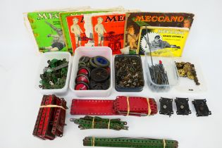 Meccano - A quantity of vintage Meccano parts including wheels, cogs and sprockets, fixings,