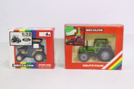 Britains. Two boxed Britains Tractors appearing in VG condition in Good boxes.