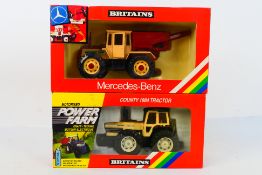 Britains. Two boxed Britains Tractors appearing in VG condition in Good boxes.