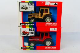 Britains. Two boxed Britains Tractors appearing in VG condition in Good boxes.
