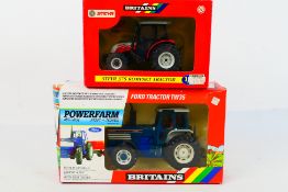 Britains. Two boxed Britains Tractors appearing in VG condition in Fair - Good boxes.