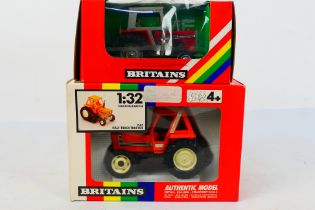 Britains. Two boxed Britains Tractors appearing in VG condition in Good boxes.