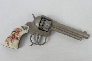 Mondial - A vintage Mondial Pecos Bill cap gun with white plastic hand grips with horse and rider