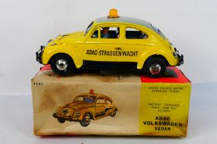 Bandai - A boxed battery powered tinplate Volkswagen Beetle in ADAC livery with bump and go action.
