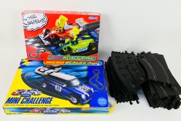 Scalextric - Two boxed Micro Scalextric sets with a quantity of loose Scalextric track.