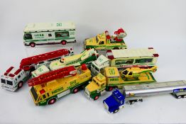 Hess - A collection of battery powered trucks in play worn condition, some have discoloured,