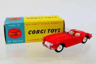 Corgi - A boxed MGA Roadster in bright red with flat wheel hubs # 302.