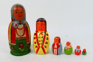 Unknown Maker - 6 x vintage wooden nesting dolls with a partial makers label on the bottom showing