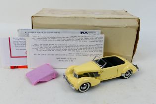Franklin Mint - A boxed Franklin Mint 1937 Cord 812 Coupe, includes paperwork, tag in tact,