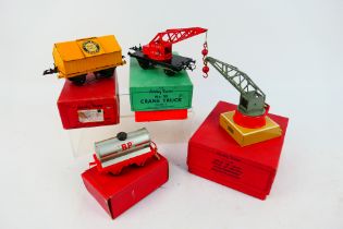 Hornby - Four boxed O gauge items of rolling stock and a platform accessory.