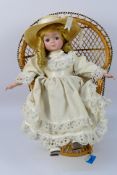 Chili - A porcelain Chili doll wearing a white dress and straw hat - Doll is presented on a