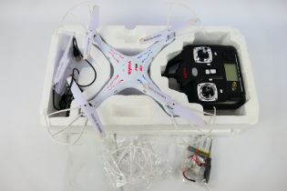 Syma - A partially boxed Syma X5C RC quadcopter / drone.