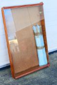 A scratch built vertical wall mounted glass display cabinet.