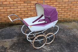 Tri-ang - A vintage metal bodied dolls pram with folding hood by Tri-ang which measures