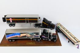 Franklin Mint - 2 x unboxed American trucks in a glass display case.