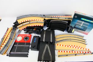 Scalextric - A quantity of slot car track sections, track side barriers, a boxed lap counter timer,