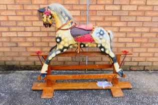 Rocking Horse - Collinson - A carved wood dappled rocking horse, with tack, mane and tail,