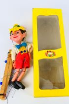 Pelham Puppets - A boxed #SL7 Pinocchio Pelham Puppet - Comes in yellow box.