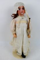SFBJ - A French bisque head doll with fixed paperweight eyes open mouth with upper teeth showing