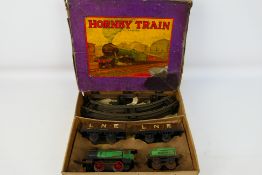 Hornby - A boxed O gauge clockwork Goods Train set # M1 with loco and tender, 2 x wagons and track.