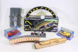 Scalextric - 3 x boxed slot cars with a box of spare parts, track side barriers,